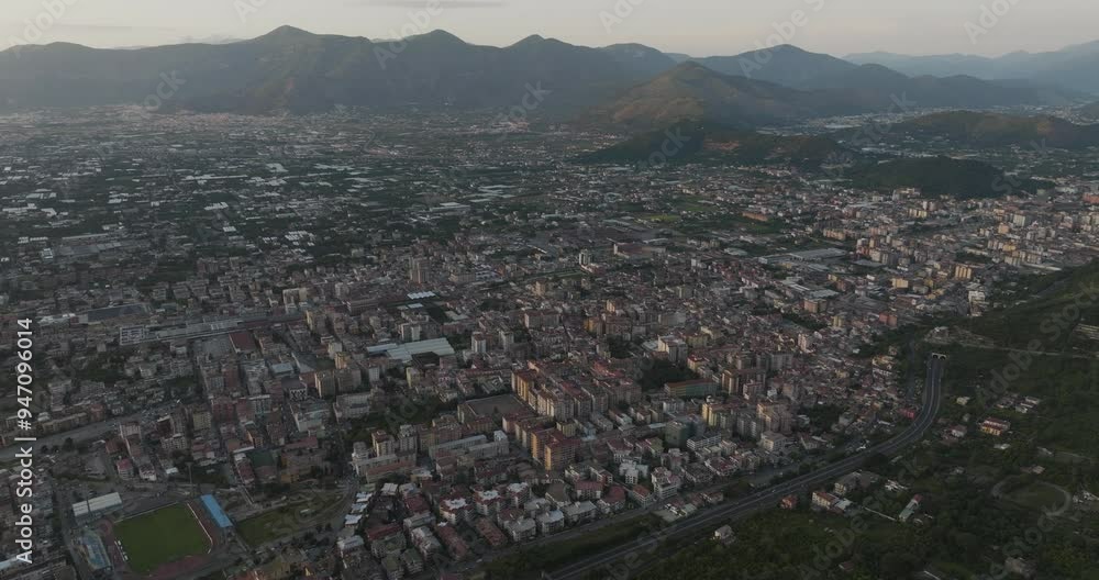 Aerial view of picturesque cityscape with beautiful rooftops and serene mountains during sunset, Sant'Egidio del Monte Albino, Campania, Italy. Aerial view of picturesque cityscape with beautiful rooftops and serene mountains during sunset, Sant'Egidio del Monte Albino, Campania, Italy.