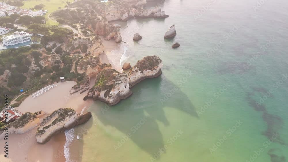Aerial view of beautiful Praia dos Tres Irmaos beach with cliffs and clear water, Portimao, Portugal. Aerial view of beautiful Praia dos Tres Irmaos beach with cliffs and clear water, Portimao, Portugal.