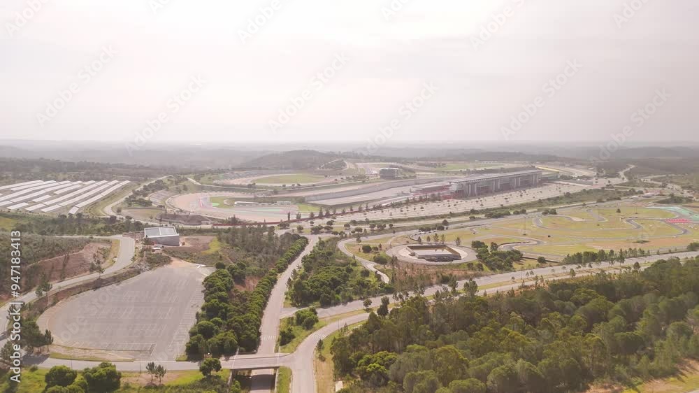 Aerial view of the beautiful Autodromo Internacional de Algarve surrounded by scenic landscape and trees, Portimao, Portugal. Aerial view of the beautiful Autodromo Internacional de Algarve surrounded by scenic landscape and trees, Portimao, Portugal.
