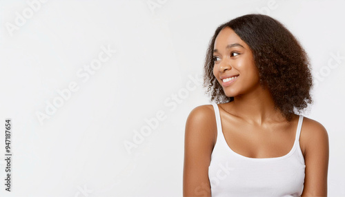 A portrait of a Black woman wearing white clothing and smiling.