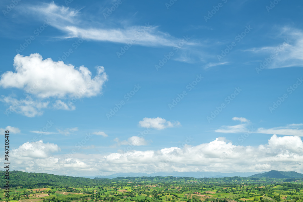 Beautiful white clouds and blue sky with beautiful natural landscape of mountains.