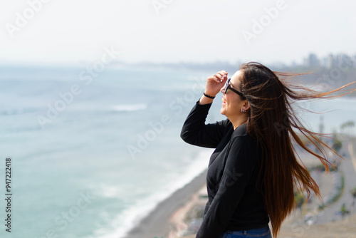 Portrait of latin woman in the sun with natural background, happy expression