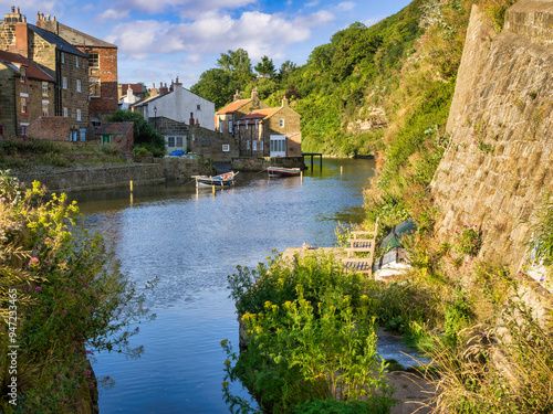 Staithes, North Yorkshire, UK - Fishing village of Staithes at high tide on a sunny summer morning. photo