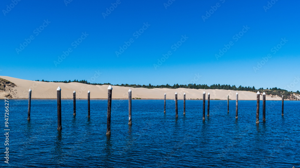 Siuslaw River with sand dunes, Florence, OR Siuslaw River with sand dunes, Florence, OR