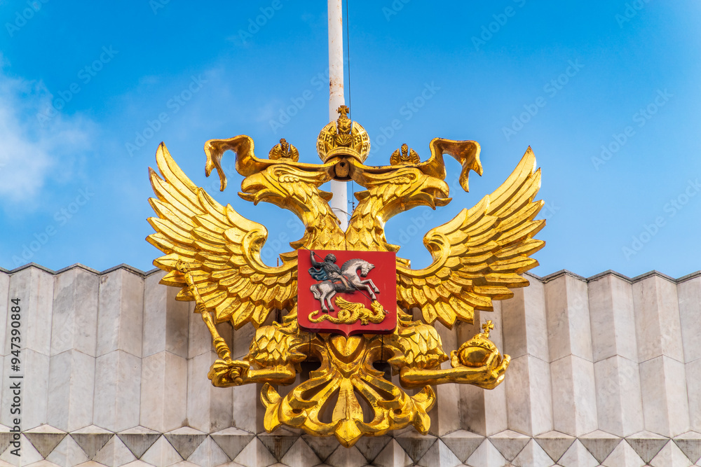 Double golden eagle. Coat of arms of Russia on the roof top of the Big Kremlin concert hall Double golden eagle. Coat of arms of Russia on the roof top of the Big Kremlin concert hall