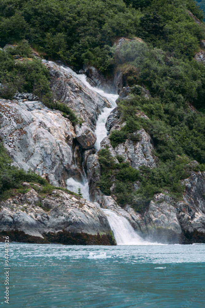 Naklejka premium Waterfall in Tracy Arm fjord south of Juneau Alaska in Tongass National Forest during summer