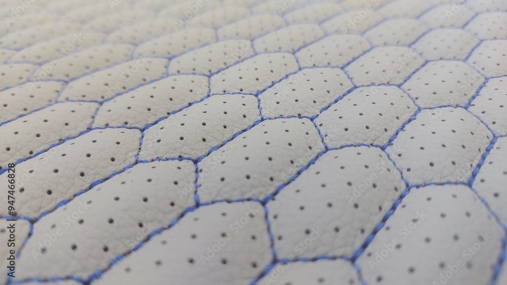 Fototapeta premium Leather blue stitched with perforated pattern honeycomb black texture or background 