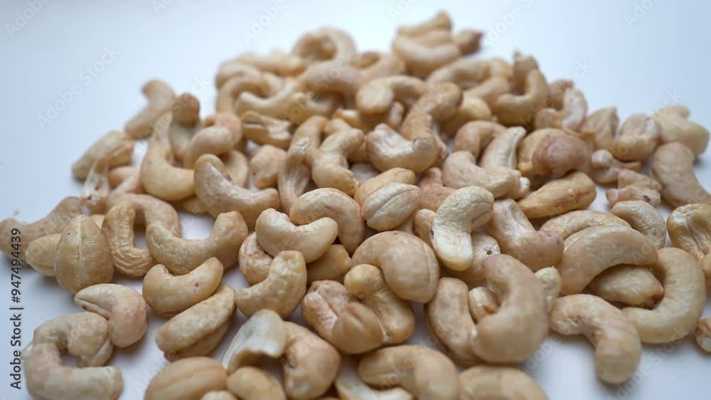 Fresh cashew nuts slide view on white background Fresh cashew nuts slide view on white background