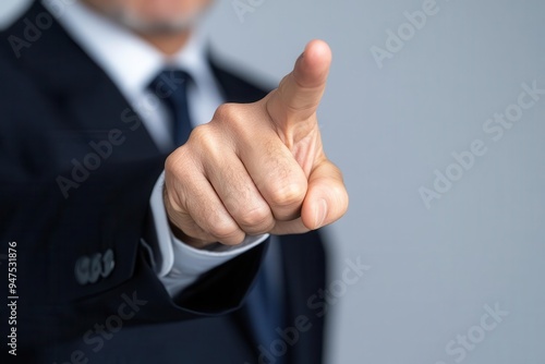A business professional gestures assertively with a finger pointing, emphasizing a strong message or directive in a corporate setting.
