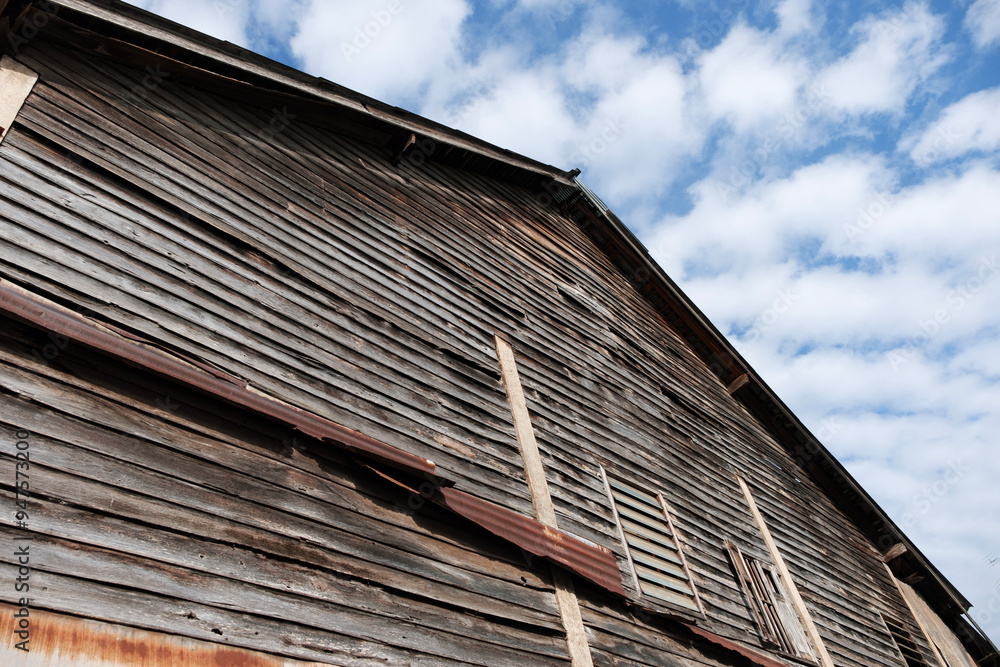 Old wooden wall, texture of the wall of an old Asian wooden house with daytime sky. Old wooden wall, texture of the wall of an old Asian wooden house with daytime sky.