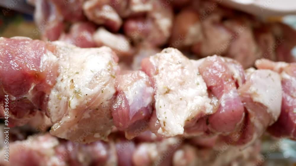 Pieces of raw pork meat on a skewer before cooking shish kebab. Pieces of raw pork meat on a skewer before cooking shish kebab.