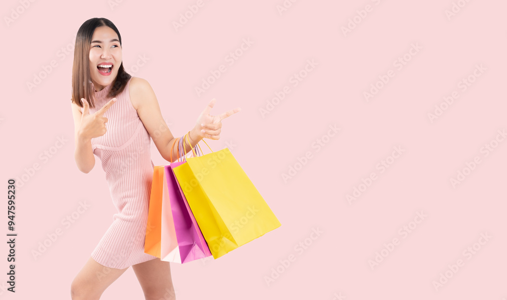 Joyful young woman in a pink dress holding colorful shopping bags, expressing excitement against a soft pink background, capturing the thrill of a successful shopping experience Joyful young woman in a pink dress holding colorful shopping bags, expressing excitement against a soft pink background, capturing the thrill of a successful shopping experience