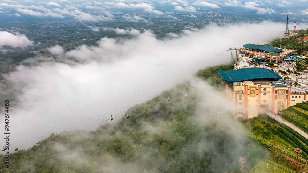Ba Den mountain tourist area. The longest cable car at Ba Den mountain in cloud sky. Below is forest. Ba Den mountain tourist area. The longest cable car at Ba Den mountain in cloud sky. Below is forest.