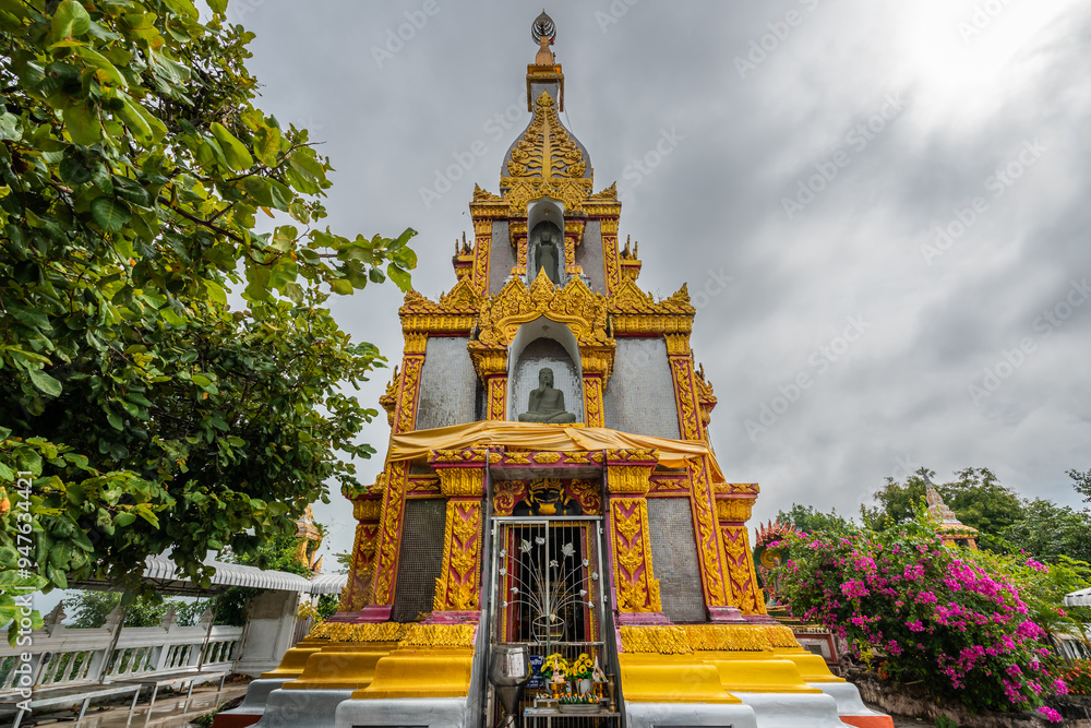 Fototapeta premium The gold stupa on the mountain at Wat Phra That Phu Khao Ngoen, Ubon Ratchathani, Thailand