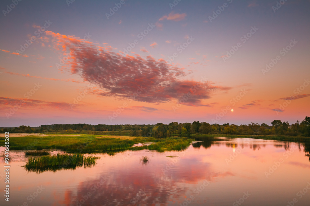 Fototapeta premium River Landscape In Belarus Or European Part Of Russia In Sunset Time Of Summer Evening. Moon Rising Over Water Lake Or River. Nature At Sunny Evening.