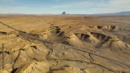 Aerial view of rugged rock textures and barren canyon formations in a vast valley, Teec Nos Pos, United States. photo