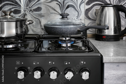 The gas burns in the burner of a kitchen stove in home kitchen. photo