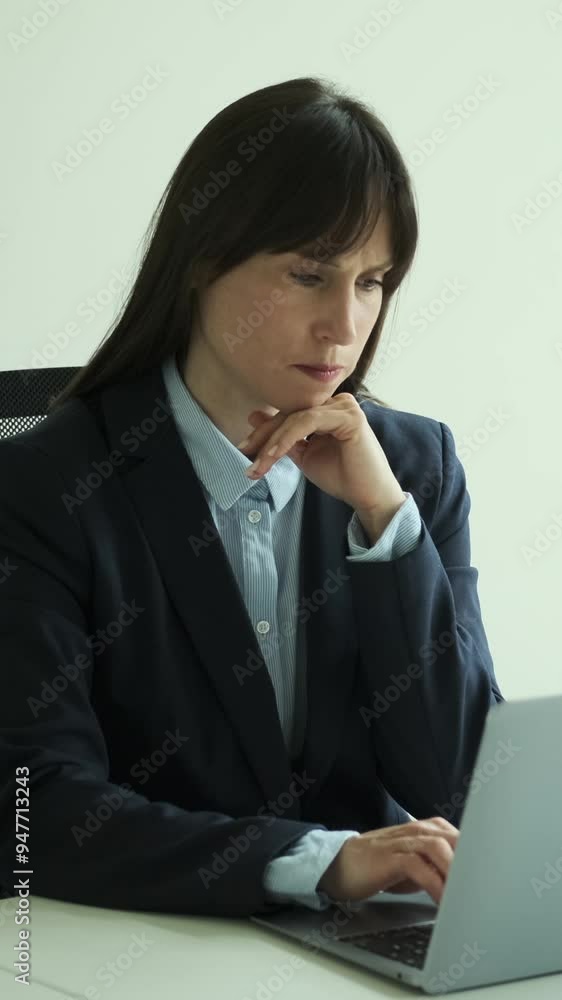 Caucasian female office worker thinking and having brilliant idea while using laptop, working in the office. Inspiration concept. Vertical video. Caucasian female office worker thinking and having brilliant idea while using laptop, working in the office. Inspiration concept. Vertical video.
