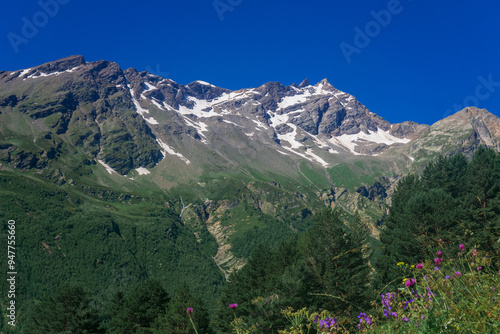 mountain landscape with slope with blurred alpine weadows on a foreground photo