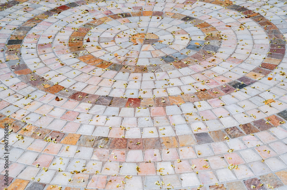 Ornate pebble pattern. The background is made of smooth stone. The texture of the paving is made of gray cobblestones. Ornate pebble pattern. The background is made of smooth stone. The texture of the paving is made of gray cobblestones.
