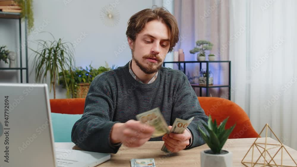 Planning budget. Rich happy man counting money cash use laptop computer calculate domestic bills at home table. Caucasian guy satisfied of income salary earnings, money for planned vacation gifts Planning budget. Rich happy man counting money cash use laptop computer calculate domestic bills at home table. Caucasian guy satisfied of income salary earnings, money for planned vacation gifts
