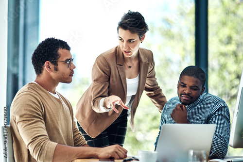 Manager, office and business people on laptop in discussion for planning, teamwork and project ideas. Corporate company, collaboration and men and women talking for feedback, review and meeting