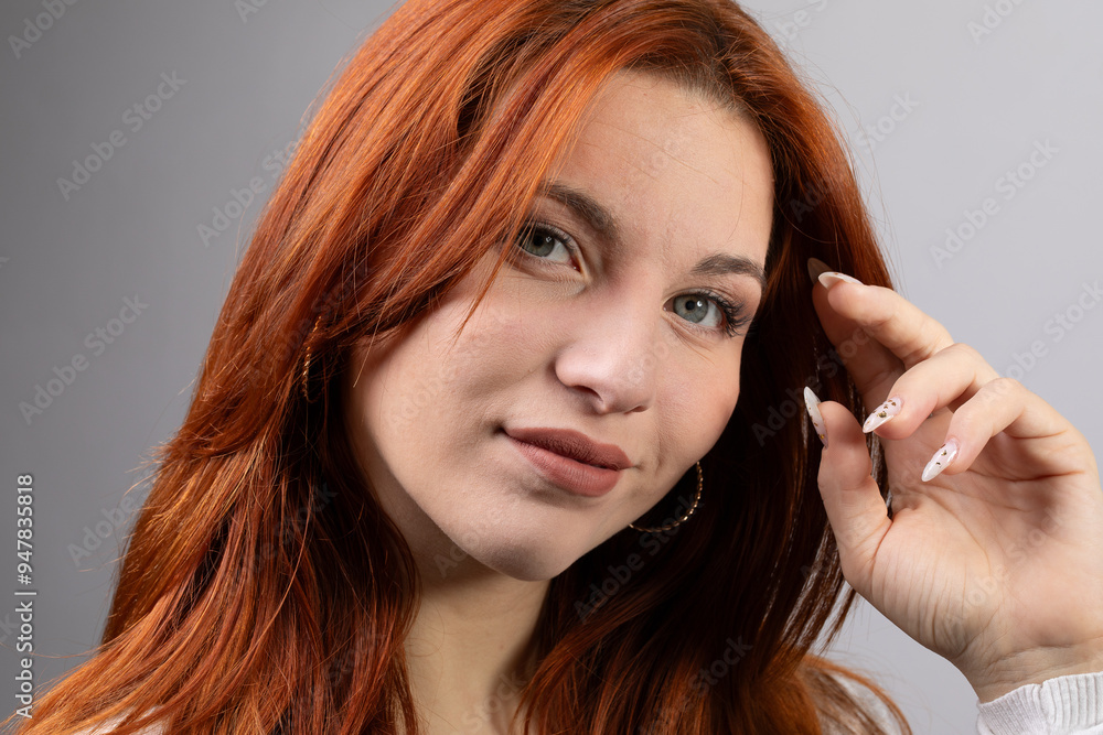 Naklejka premium Beautiful red hair woman touching her head and smiling