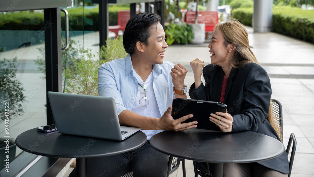 Two businessmen are happy that they have achieved their goals at a modern coffee shop. Two businessmen are happy that they have achieved their goals at a modern coffee shop.