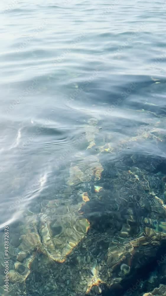 View from the surface of the calm sea with beautiful rays of reflected light. View from the surface of the calm sea with beautiful rays of reflected light.