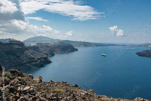 View of Skaros rock, a rocky headland that protrudes out to the azure blue Aegean Sea, Imerovigli, Santorini, Greece. This was on a hot sunny afternoon. photo