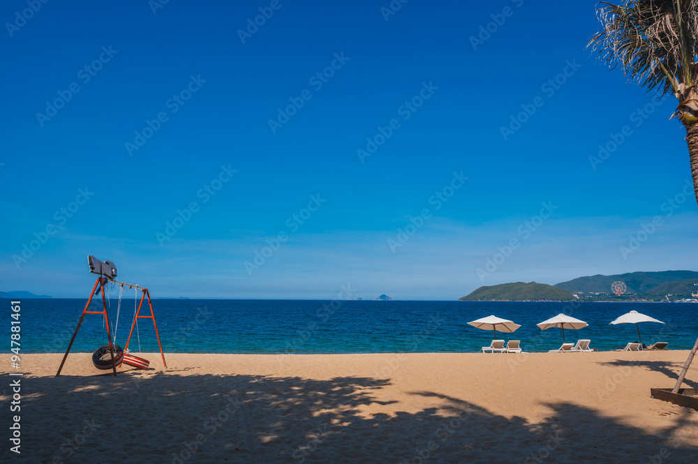 beach umbrellas with sun loungers without people on a sandy beach against the background of the sea. beach umbrellas with sun loungers without people on a sandy beach against the background of the sea.