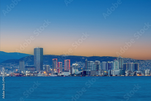 Obraz na płótnie Bayraklı, Karşıyaka, İzmir, Turkey: August 20, 2024, view of the İzmir Bay from Karşıyaka at night. Long exposure, low light. w salonie