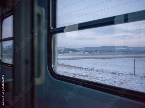 snowy scenery of country side seen from the train window in poland