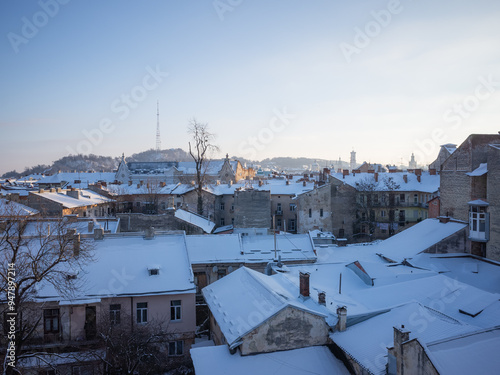 winter scenery with snow covered buildings in lviv old city photo