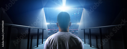 Soccer player entering stadium tunnel before match. Background is an imaginary stadium that is modelled and rendered.