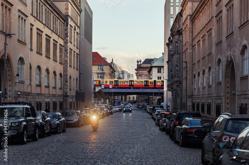 Scenic evening view Geschwister-Scholl street and S-bahn subway train bridge in Berlin Mitte central district at dusk sunset. Urban european transport commute cityscape Germany scene background