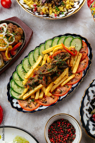 Wallpaper Mural sliced cucumbers and tomatoes on a plate with meat and potatoes Torontodigital.ca