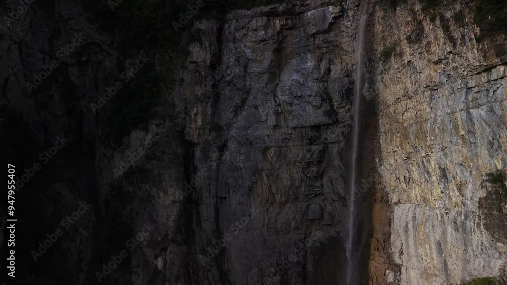 Klöntalersee waterfall falls in Switzerland, Swiss Alps mountain cliff Klöntalersee waterfall falls in Switzerland, Swiss Alps mountain cliff