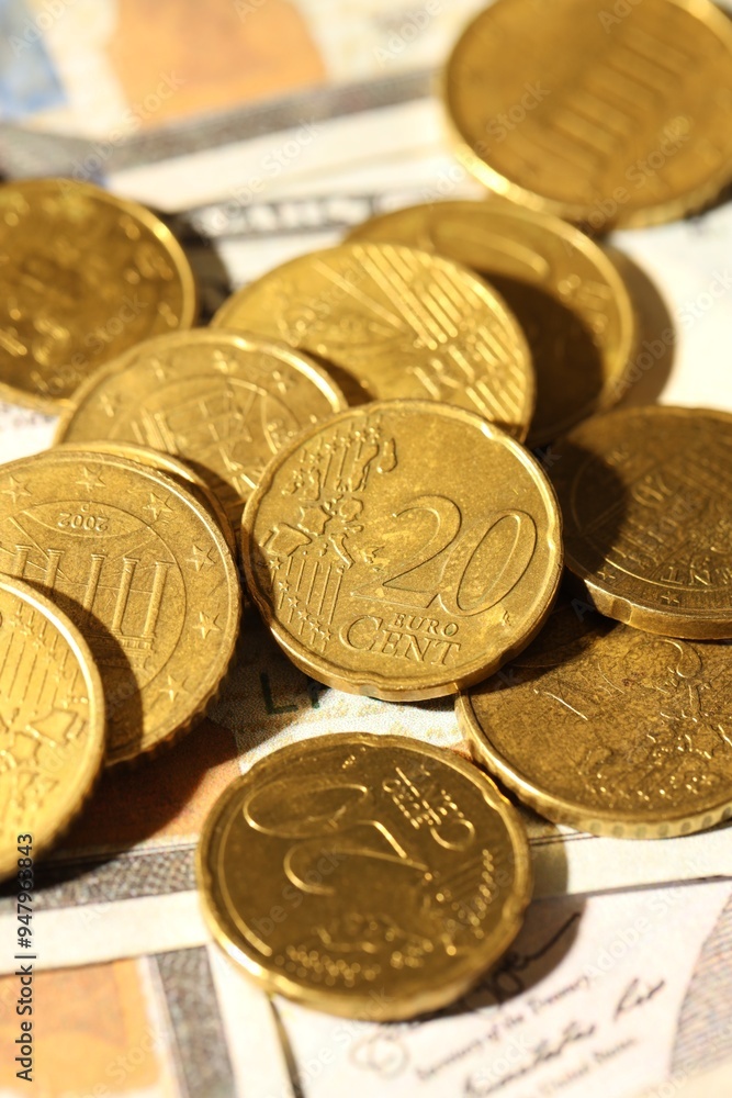 Many euro coins on dollar banknotes, closeup Many euro coins on dollar banknotes, closeup