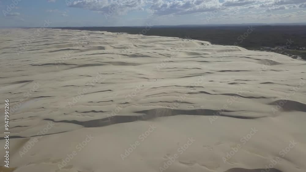 Aerial view of expansive sand dunes under a sunny sky, Worimi National Park, Anna Bay, New South Wales, Australia. Aerial view of expansive sand dunes under a sunny sky, Worimi National Park, Anna Bay, New South Wales, Australia.