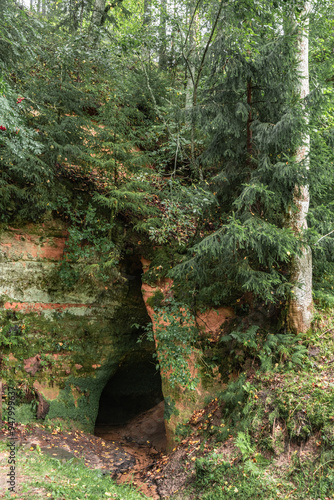 Devil’s Cave (latvian: Velna ala) in a Skanaiskalns (latvian: Skaņaiskalns) Nature Park on Salaca river in Mazsalaca, Latvia photo