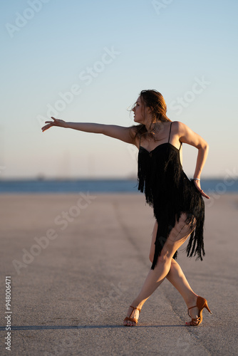 beautiful girl dancing rumba at sunset