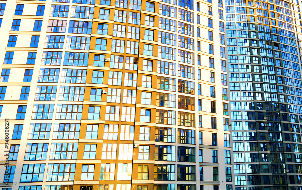 Glass facade building background, texture. Glass windows of the modern building. Glasses wall waving exterior in High rise residential house. Modern building glass wall, metal frame construction. Glass facade building background, texture. Glass windows of the modern building. Glasses wall waving exterior in High rise residential house. Modern building glass wall, metal frame construction.
