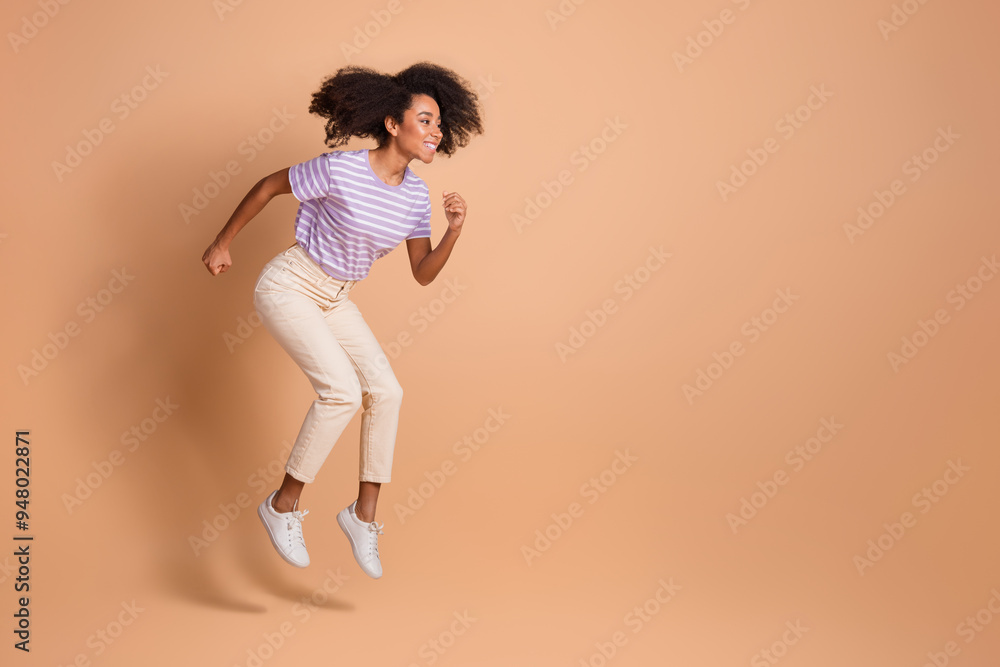 Full size photo of pretty young woman jump run empty space wear t-shirt isolated on beige color background Full size photo of pretty young woman jump run empty space wear t-shirt isolated on beige color background