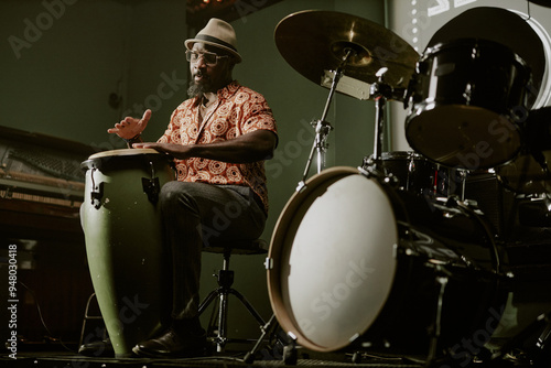 Canvas Print Low angle view of bearded African American man playing conga during jazz perform