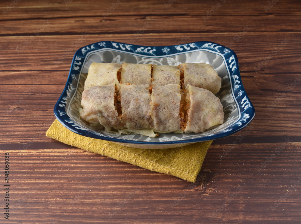 Homemade traditional asian food nyonya Popiah Spring Roll fresh vegetables, bean curd, fried shallots, dried shrimp, sweet chili paste and braised turnip on wood table vegan halal menu for cafe