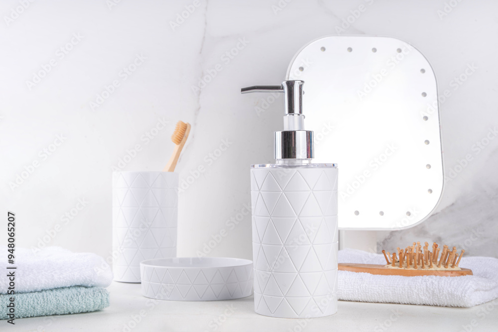 Naklejka premium Bathroom shelf simple white background. Dispenser for soap, shower gel, soap dish, glass with toothbrushes, stack of towels on countertop. Mockup for cosmetics, body care products, copy space