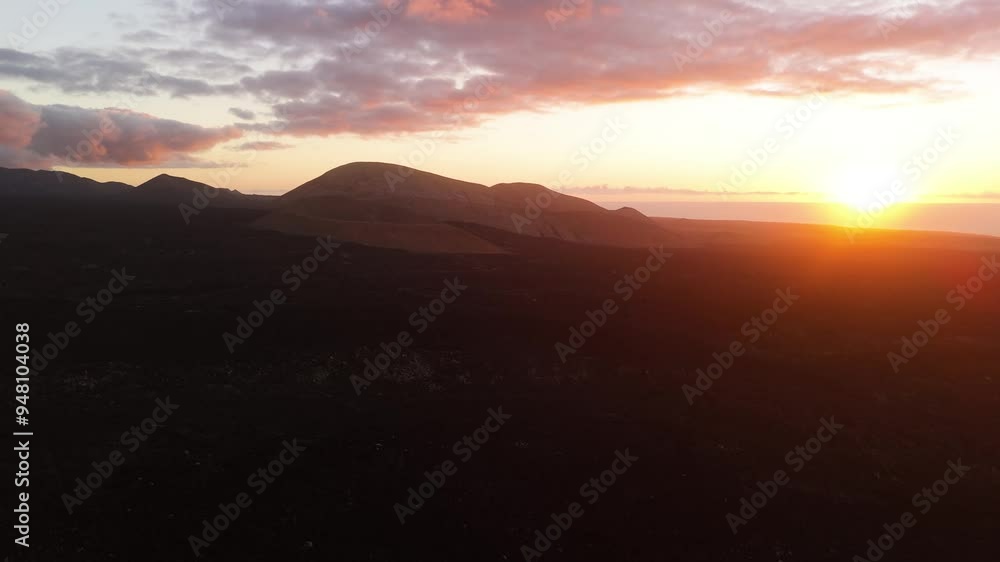 Aerial view of Caldera Blanca at sunset with majestic mountains and serene sky, Tajaste, Lanzarote, Spain. Aerial view of Caldera Blanca at sunset with majestic mountains and serene sky, Tajaste, Lanzarote, Spain.