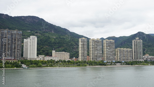 Qingtian landscape with some chinese buildings, the mountains, the river Ou, Oujiang in Zhejiang, near Lishui in China photo