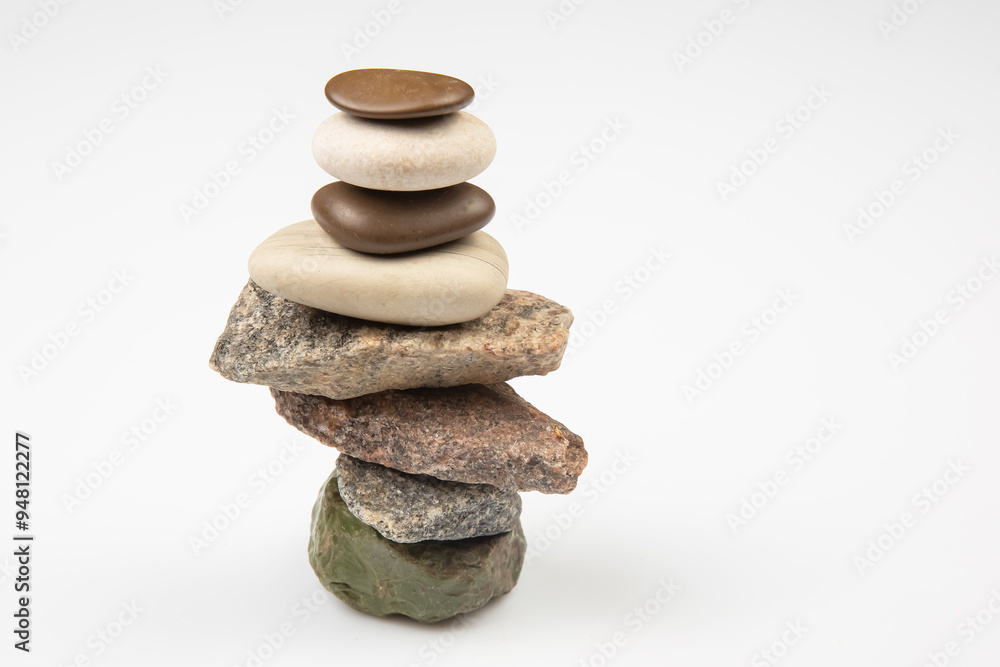 pyramid of stacked stones on a white background. stabilization and balance in life pyramid of stacked stones on a white background. stabilization and balance in life